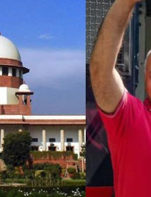 Manish Sisodia, smiling, standing next to the dome of the Supreme Court of India building.